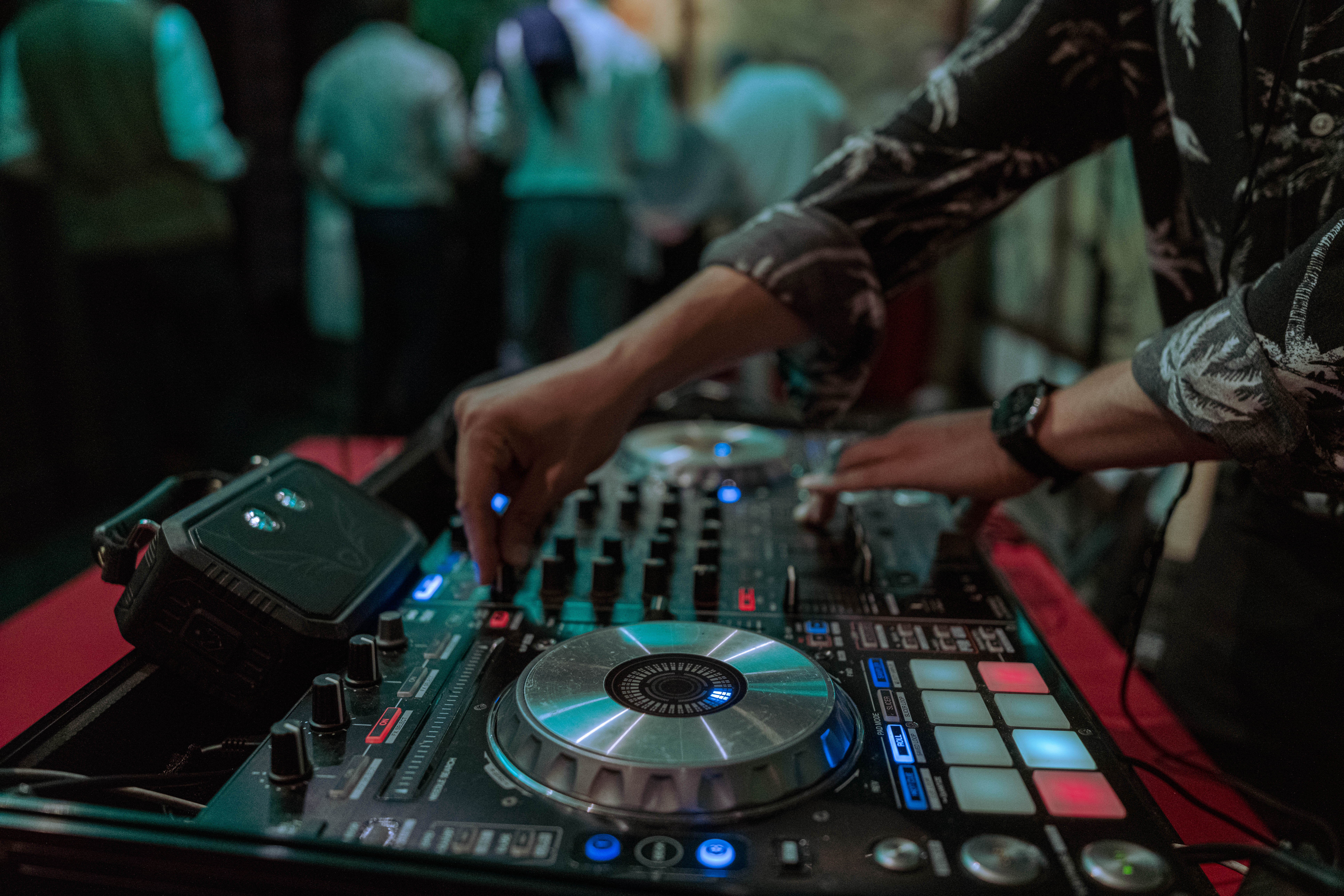 Close-up of a DJ mixing on a controller during an event.
